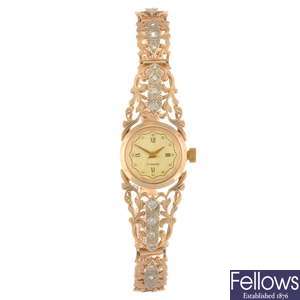 (707005119) A 14k gold manual wind lady's bracelet watch.