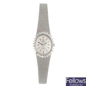 An 18k white gold manual wind lady's Omega bracelet watch.