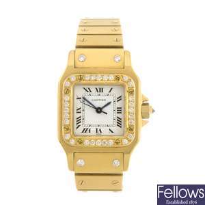 An 18k gold automatic Cartier Santos bracelet watch.
