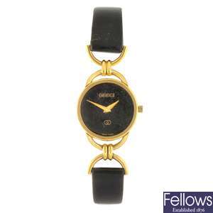 A gold plated quartz lady's Gucci 6000L wrist watch.