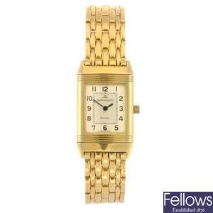 An 18k gold quartz lady's Jaeger LeCoultre Reverso bracelet watch.