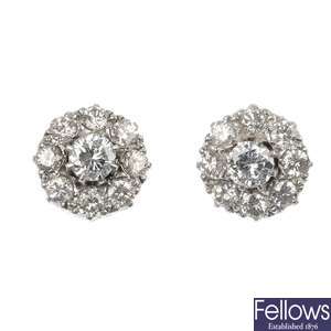A pair of diamond cluster earrings.