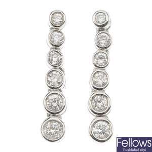 A pair of 18ct gold diamond ear pendants.