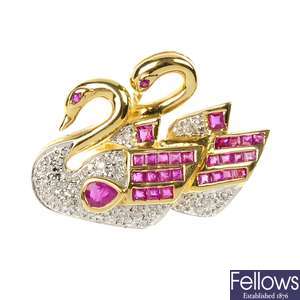 A ruby and diamond double swan brooch.