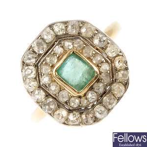 An early 20th century gold emerald and diamond cluster ring.
