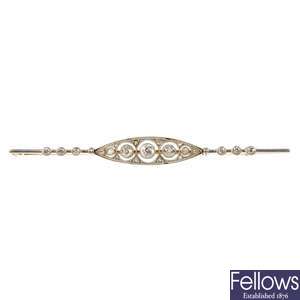 An early 20th century 12ct gold and platinum diamond bar brooch. 