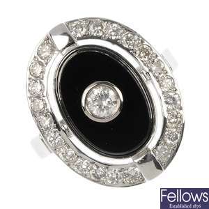 An 18ct gold diamond and onyx ring.