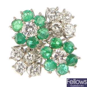 An 18ct gold emerald and diamond double cluster ring.
