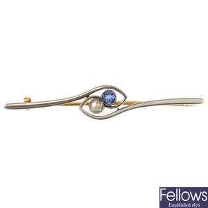 An early 20th century platinum and gold diamond and synthetic sapphire bar brooch.