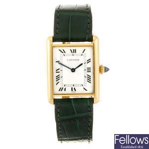 An 18k gold manual wind Cartier Tank wrist watch.
