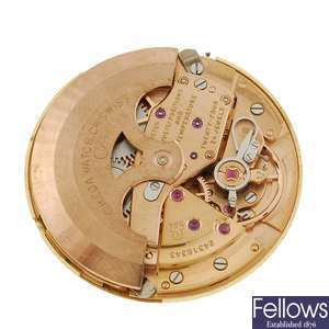 An Omega watch movement and dial.