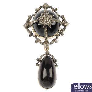 A mid 20th century silver and gold garnet and diamond brooch.