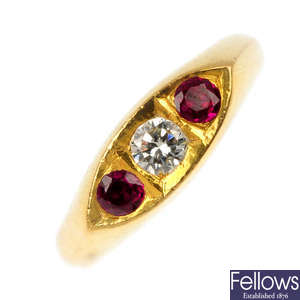 A diamond and synthetic ruby three-stone ring.
