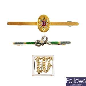 Two early 20th century gold gem-set brooches and a split pearl and enamel slider.