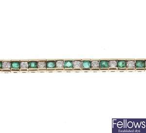An emerald and diamond line bracelet.