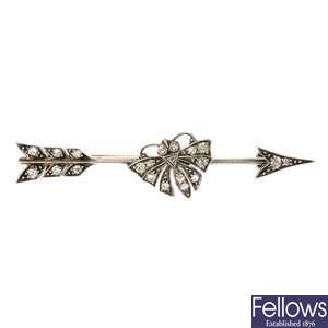 A late 19th century silver and gold diamond arrow and butterfly brooch.