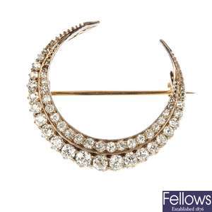 A late Victorian silver and gold diamond crescent brooch.