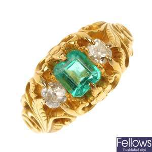 A mid 20th century 22ct gold emerald and diamond three-stone ring.