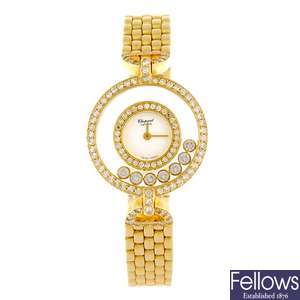 An 18k gold quartz lady's Chopard Happy Diamonds bracelet watch.