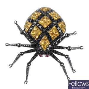 LOT:448 | A sapphire, ruby and black-gem spider brooch.