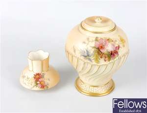 A Royal Worcester porcelain vase of baluster form with original inner cover