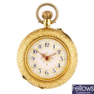 An 18k gold keyless wind open face fob watch.