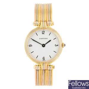 An 18k gold quartz Cartier Vendome bangle watch.