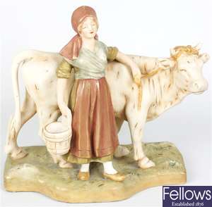 An early 20th century Royal Dux figure group modelled as a milk maid with cow