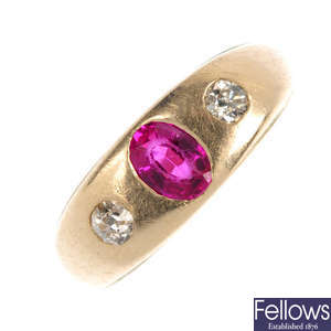 A synthetic ruby and diamond three-stone ring.