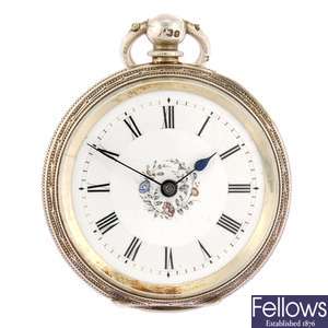 A silver keyless wind open face pocket watch with another pocket watch and chain.