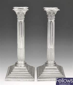 An Edwardian pair of silver mounted Corinthian capital candlesticks.