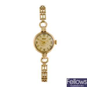 A 9ct gold manual wind lady's Tissot bracelet watch.