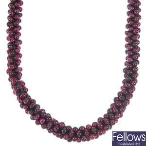 A garnet bead necklace and matching bangle.