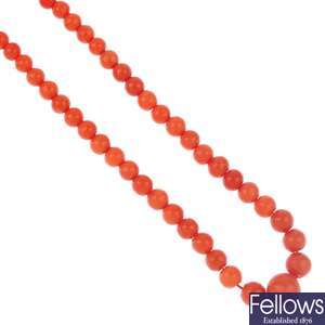 A coral necklace with diamond clasp.