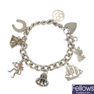 A selection of three silver and white metal charm bracelets.