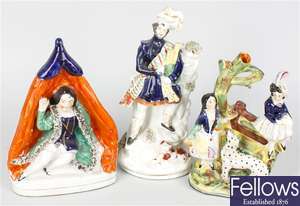 A collection of 19th century and later Staffordshire pottery flatback figures and animals