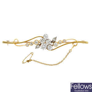 A diamond floral brooch and a hair slide. 
