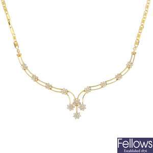 A diamond floral cluster necklace.