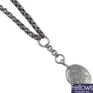 A late Victorian silver back and front locket and silver chain.