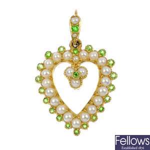An early 20th century 15ct gold split pearl and demantoid garnet heart-shape pendant.
