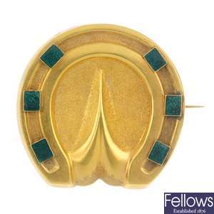 A late 19th century gold enamel memorial horseshoe brooch.
