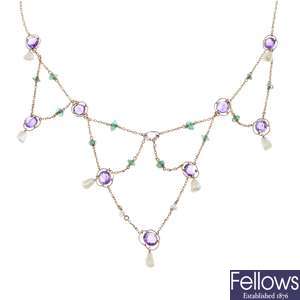An early 20th century 15ct gold amethyst, emerald and baroque pearl garland necklace.