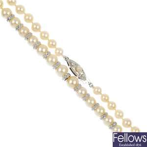 A graduated cultured pearl necklace with diamond spacers.