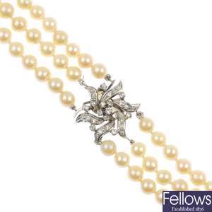 A cultured pearl three-row necklace with diamond set clasp.