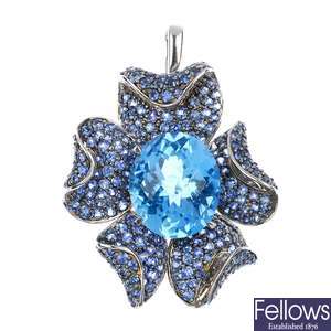 An 18ct gold topaz and sapphire floral pendant.