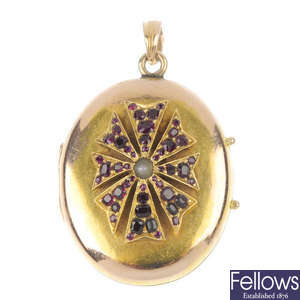 An early 20th century gold ruby and split pearl locket. 