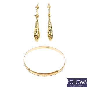 A selection of fifteen 9ct gold bangles and ten pairs of ear pendants. 