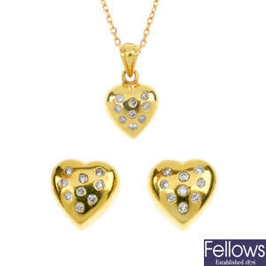 A diamond pendant and matching ear studs.