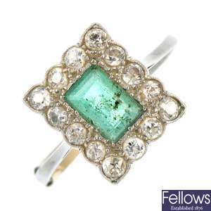 A mid 20th century platinum emerald and diamond cluster ring.