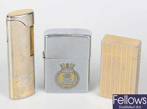 A collection of sixteen assorted cigarette lighters to include zippo and other examples